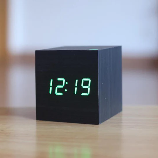 Black wooden cube clock with green LED digits